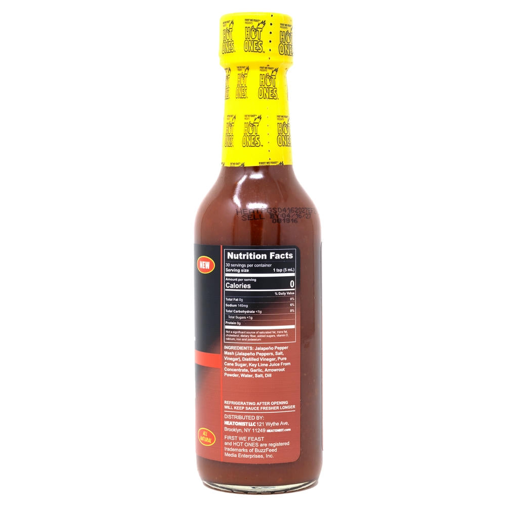 Hot sauce bottle with yellow cap and label on a white background