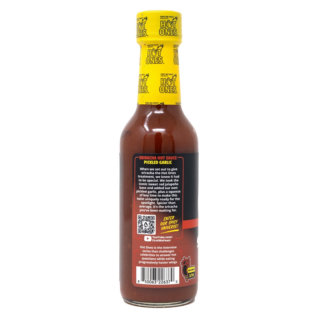 Hot sauce bottle with yellow cap and visible label on a white background