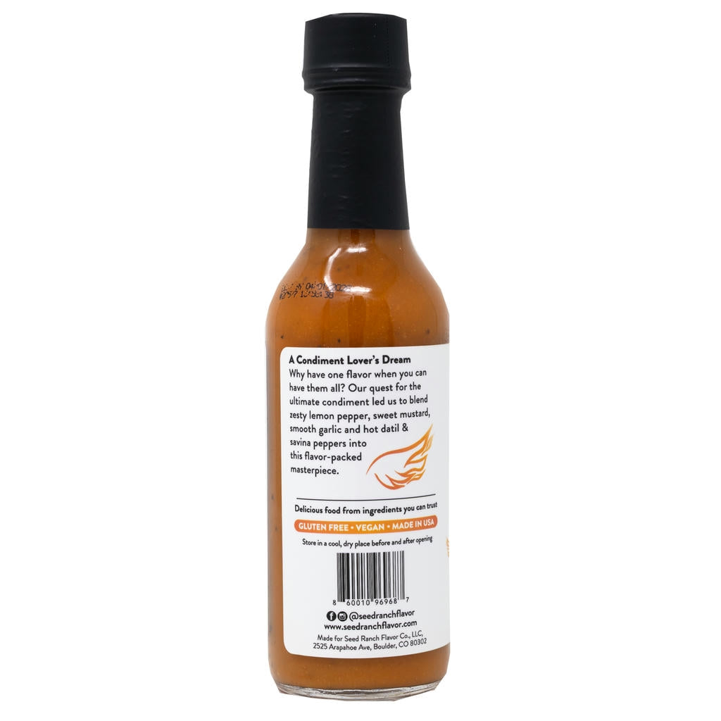 Bottle of sauce with a label on a white background