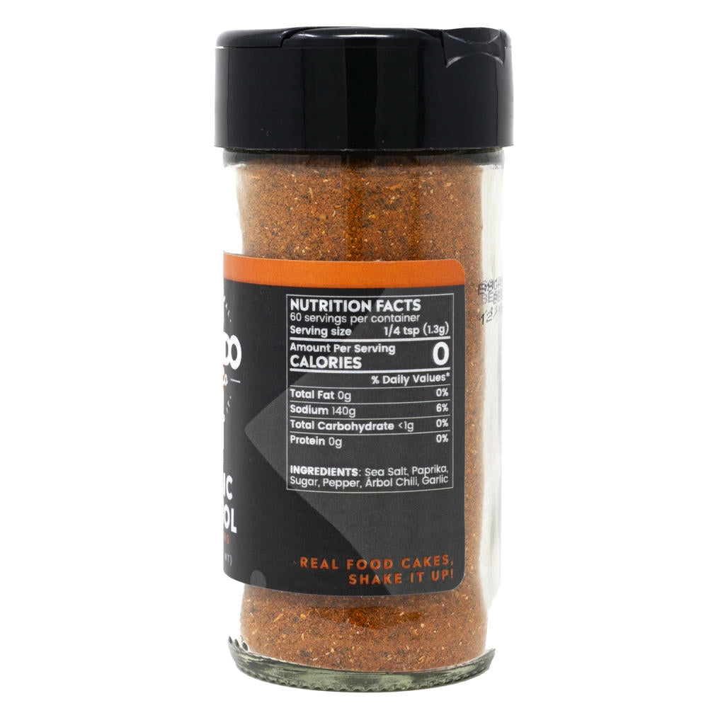 Spice jar with black lid and nutritional label on a white background