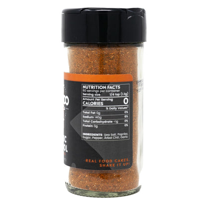 Spice jar with black lid and nutritional label on a white background