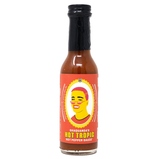 Bottle of Shaquanda's Hot Tropic hot pepper sauce on a white background