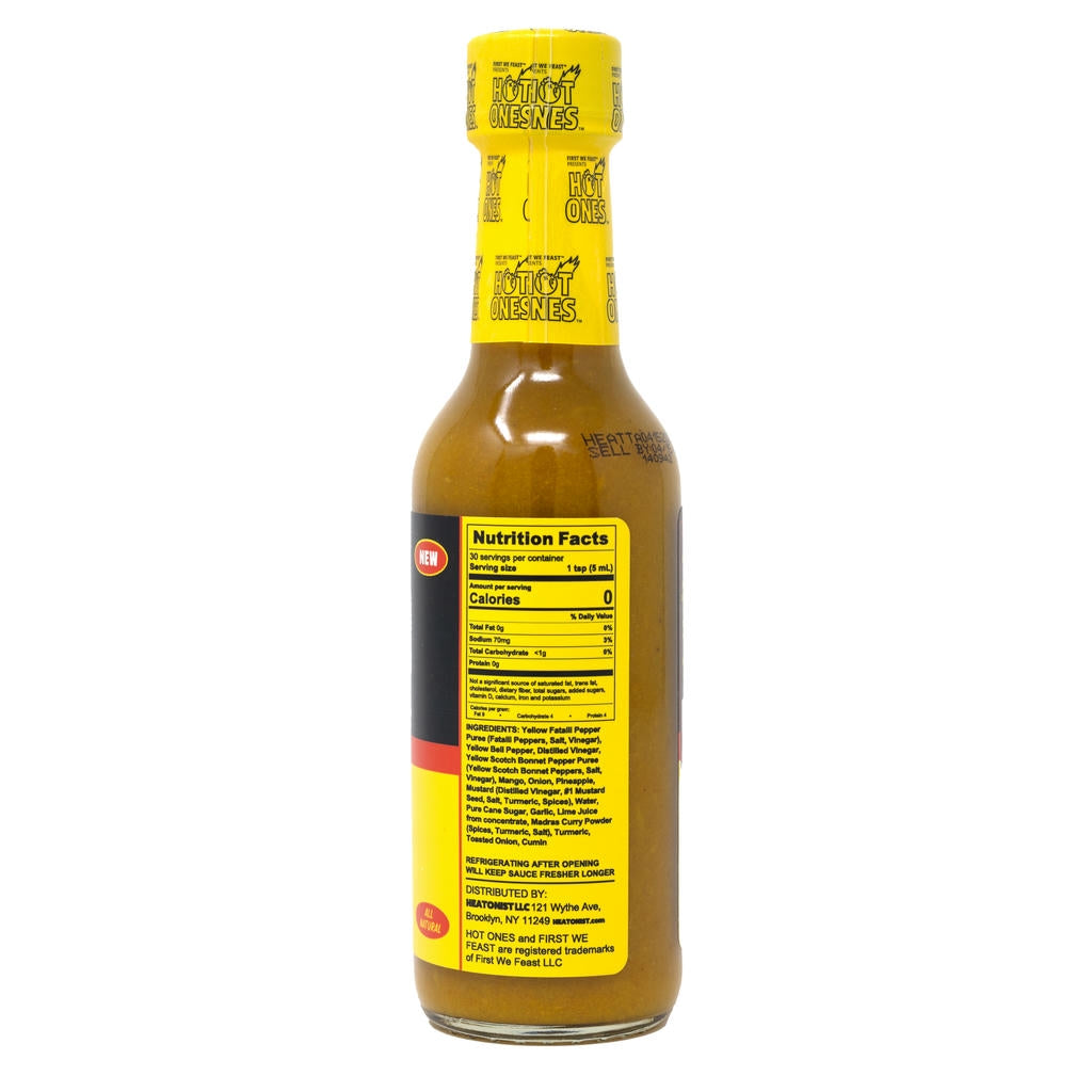 Bottle of hot sauce with a yellow label on a white background
